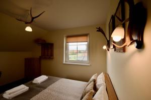 Postel nebo postele na pokoji v ubytování Šv Hubertas