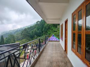 a balcony with a view of the mountains at Rupsadeya Homestay in Mangpu