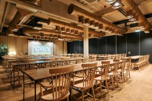 a row of tables and chairs in a room at Hotel Maestoso - Lipica in Sežana