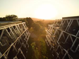 an overhead view of a building with the sun in the background at Hotel Maestoso - Lipica in Sežana