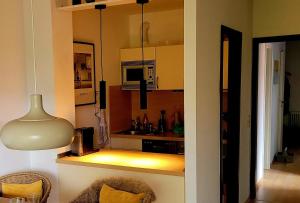 a kitchen with a table and a lamp in a room at Waldstraße 2 Windrose Kellenhusen in Kellenhusen