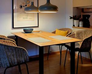 a dining room table with chairs and a bowl on it at Waldstraße 2 Windrose Kellenhusen in Kellenhusen