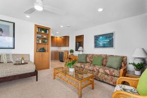 a living room with a couch and a table at Napili Surf 207 · NSF 207 BeachFront Condo Napili Bay in Kahana