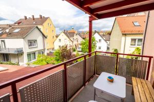 a balcony with a table and a view of a city at AugsburgLiving - Business- und Ferienapartments in Augsburg