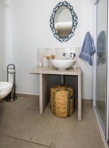 a bathroom with a sink and a mirror at LIMA HOUSE, Seaforth, Simon's Town in Simonʼs Town