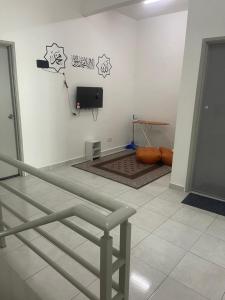 a room with a flat screen tv on a wall at Anis Homestay MELAKA in Melaka +1 photo