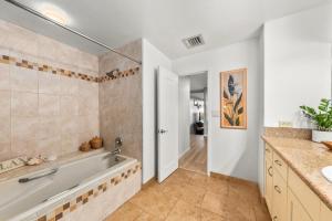 a bathroom with a tub and a sink at Kaanapali Royal H101 · KRL H101 Remodel 2BD Condo Pool Kaanapali in Kaanapali +51 photos