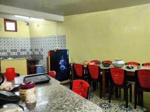 a room with a table and some red chairs at Rupsadeya Homestay in Mangpu