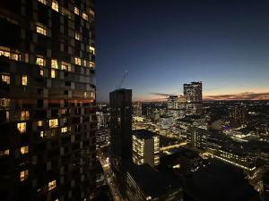 a view of a city skyline at night at Meriton Parramatta in Sydney