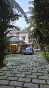 a car parked in front of a house at Thistle Cosy Villa in Kozhikode