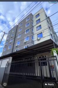 a tall white building with blue windows at Hidden gem-Nyali Vale Residence in Mombasa