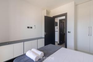 a bedroom with a bed with two towels on it at Aptos em condo. com churrasq. e piscina na melhor localização de Porto Seguro – DVBs in Porto Seguro