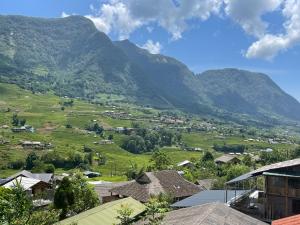 a view of a village with mountains in the background at Bình An House in Sapa