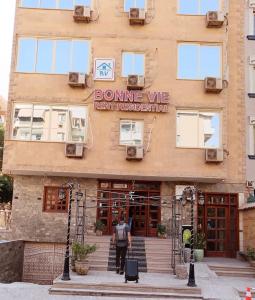 a man standing outside of a building at Bonne Vie Hotel in 6th Of October