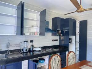 a kitchen with blue cabinets and a counter top at Hidden gem-Nyali Vale Residence in Mombasa