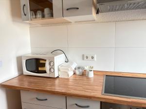 a microwave sitting on a counter in a kitchen at Three room apartment in Bad Oeynhausen Südbahnhof in Bad Oeynhausen