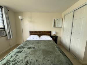 a bedroom with a large bed with two pillows at Waikiki Seaside Monarch Paradise Hotel Room Greenery Mountain View in Honolulu +28 photos