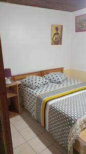 a bedroom with a bed and a small table at la kaza in Le Morne Rouge
