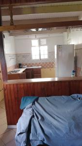 a room with a kitchen and a counter top at la kaza in Le Morne Rouge