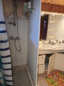 a bathroom with a shower and two sinks at la kaza in Le Morne Rouge