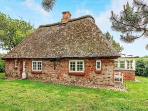 an old brick house with a grass roof at 4 person holiday home in Tønder in Tønder