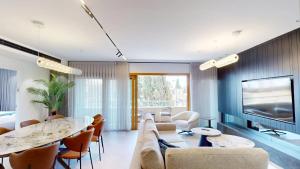 a living room with a couch and a table at KING DAVID RESIDENCES - Pool & Gym in Jerusalem