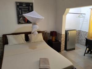 ein Schlafzimmer mit einem Bett, auf dem ein Zettel liegt in der Unterkunft Casa Cacheu Homestay in Bissau