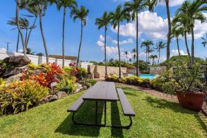 a picnic table in the grass next to a pool at Napili Ridge G16 · NR G16 Updated Napili Condo Walk to Napili Ba in Kahana