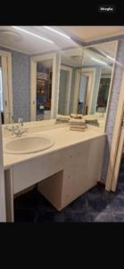 a bathroom with a sink and a large mirror at Brera home suite in Milan