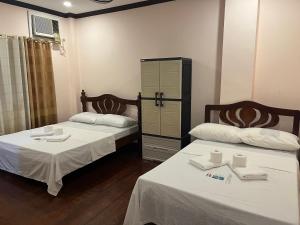 Ένα ή περισσότερα κρεβάτια σε δωμάτιο στο Roxas Pension House +65 φωτογραφίες