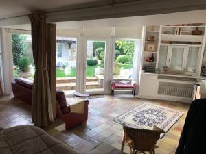 a living room with a couch and a table at Villa Fiquefleur in Fiquefleur-Équainville