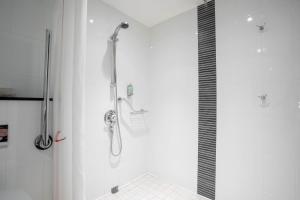 a shower in a bathroom with a glass door at Holiday Inn Glasgow City Theatreland by IHG in Glasgow