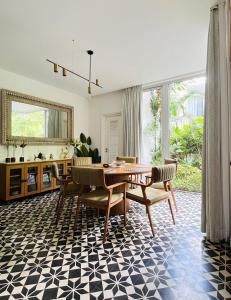a dining room with a table and chairs at Casa Calma - 2BHK Luxury Villa with Private Pool by evaddo in Siolim +32 photos