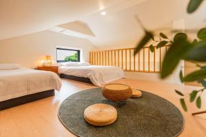 a bedroom with two beds and a circular rug at In Aewol Forest 102 in Haean