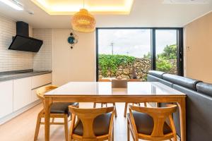 a kitchen and dining room with a table and chairs at In Aewol Forest 102 in Haean +50 photos