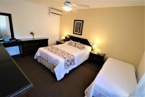 a bedroom with a bed and two dressers and a bed sidx sidx sidx sidx at Hotel Arona in Villa Carlos Paz +19 photos