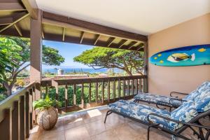 a balcony with a bench and a view of the ocean at Kaanapali Plantation 18 · KPL 18: Ocean views, beach nearby, com in Lahaina