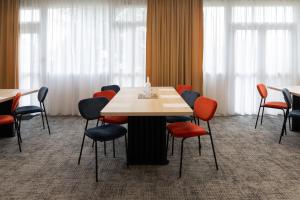 カーンにあるLe Carline, Sure Hotel Collection by Best Westernのテーブルと椅子のある会議室