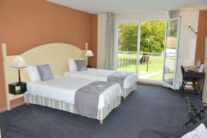 a hotel room with two beds and a window at Best Western Golf d'Albon in Albon