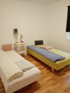 two beds sitting next to each other in a room at Ferienhaus Aäng 6 Südschweden in Vislanda