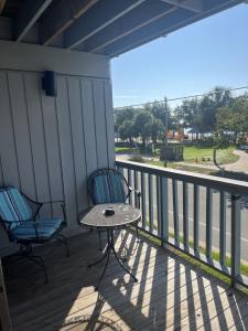 a patio with two chairs and a table on a porch at Unit 225 Beautiful Cedar key in Cedar Key