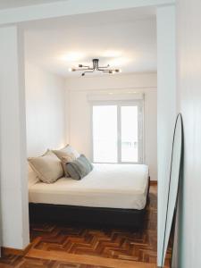 a bedroom with a large bed with a window at Casa Brown in Neuquén