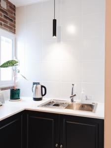 a kitchen with black cabinets and a sink at Casa Brown in Neuquén +26 photos