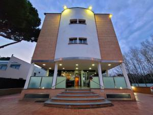 a large building with stairs in front of it at Hotel 170 in Castelldefels