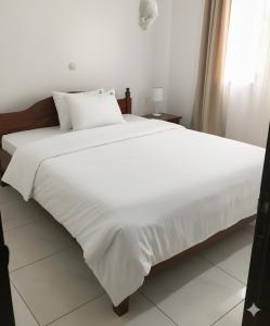 Postel nebo postele na pokoji v ubytování Jambo Guest House