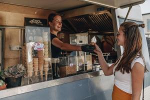 a man and a woman ordering food at a counter at Beach Resort Kamperland - 642 in Kamperland +10 photos