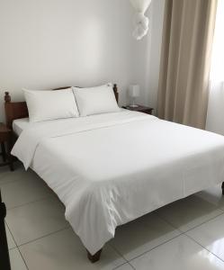 Postel nebo postele na pokoji v ubytování Jambo Guest House