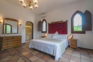 a bedroom with a white bed and two windows at Can Joan Vich ii in Can Furnet +23 photos