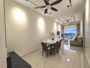 a dining room with a table and chairs and a ceiling fan at D Aman Infinity Pool and AS Tower View Homestay 05 in Alor Setar