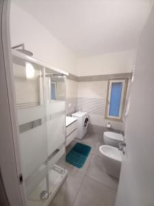 a bathroom with two toilets and a sink at La Perla del Mare in Pisciotta +37 photos